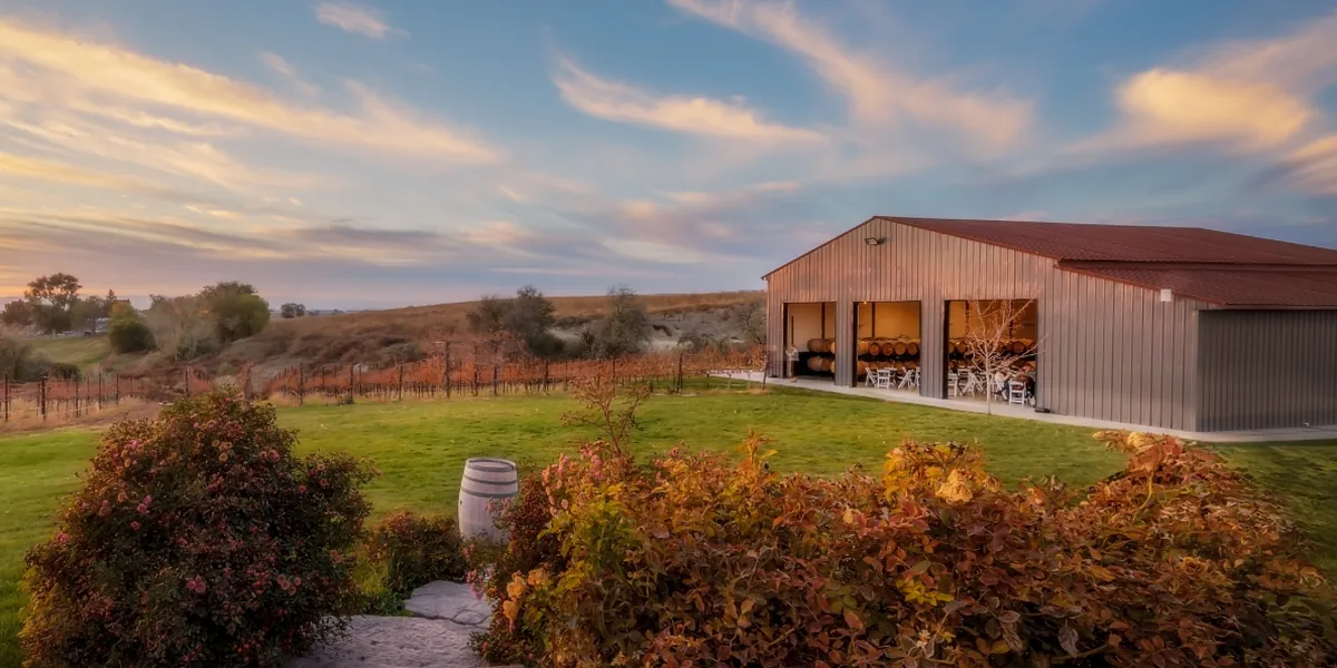 The Winery at sunset — barrel barn and vineyard rows in Sunnyslope